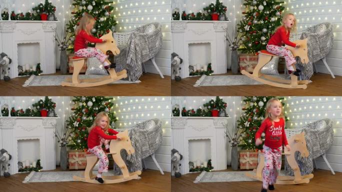 小女孩在圣诞节的玩具马上荡秋千