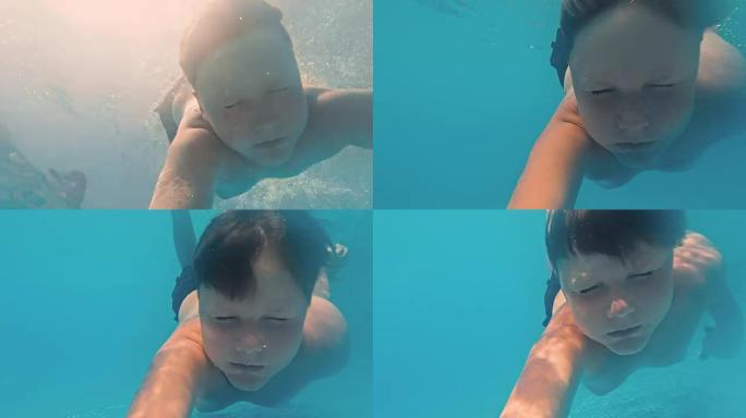 水下小男孩在游泳池里玩得开心