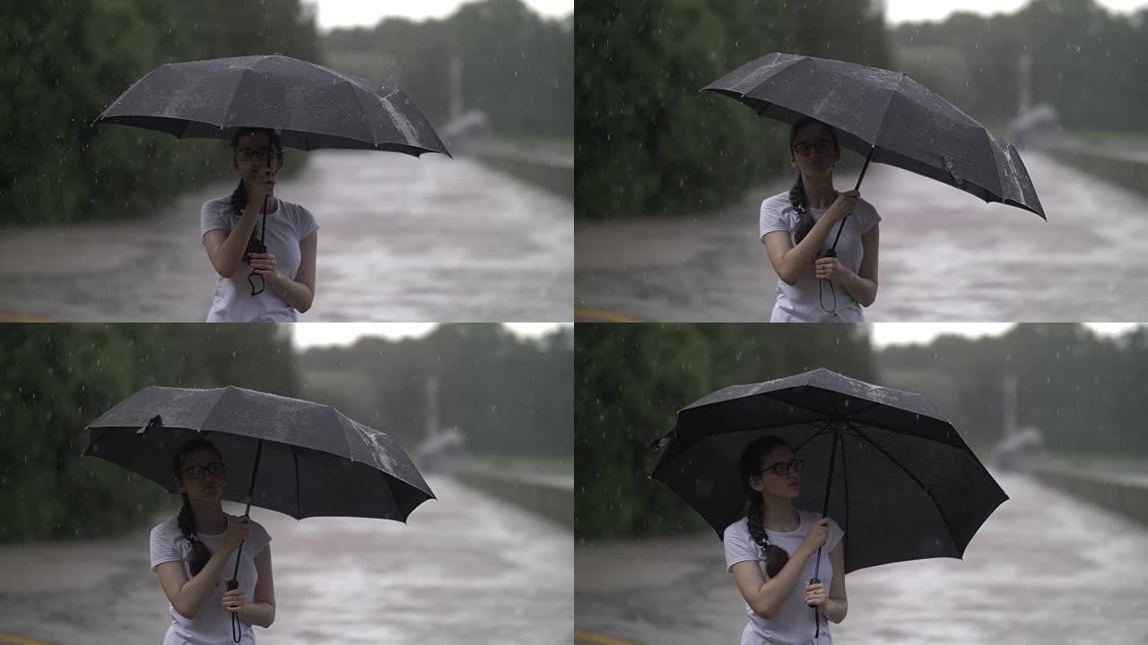 女孩在雨天旋转雨伞，看着雨滴打在雨伞上，秋天的心情，慢动作，户外