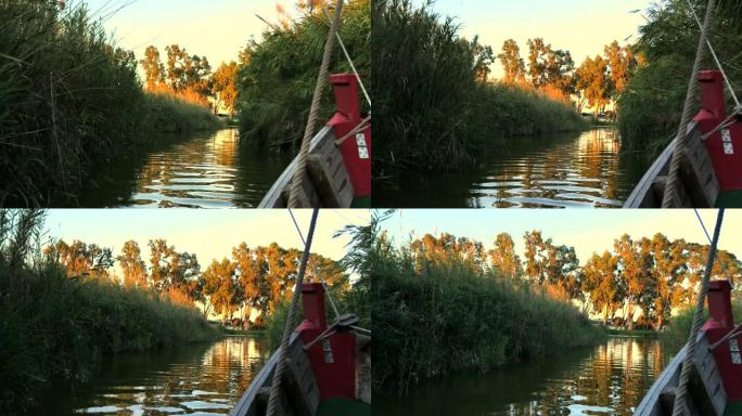 日落时在西班牙巴伦西亚的泻湖 “La Albufera” 航行