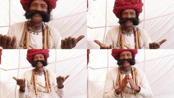 来自拉贾斯坦邦的微笑男子留着大胡子，双手合十，欢迎客人