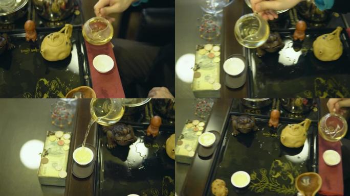 茶道。大师将绿茶从玻璃茶壶倒入白色杯子中