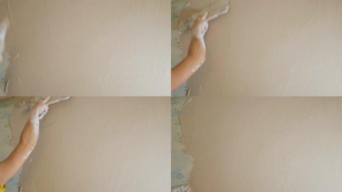 女人用调色板抹灰墙