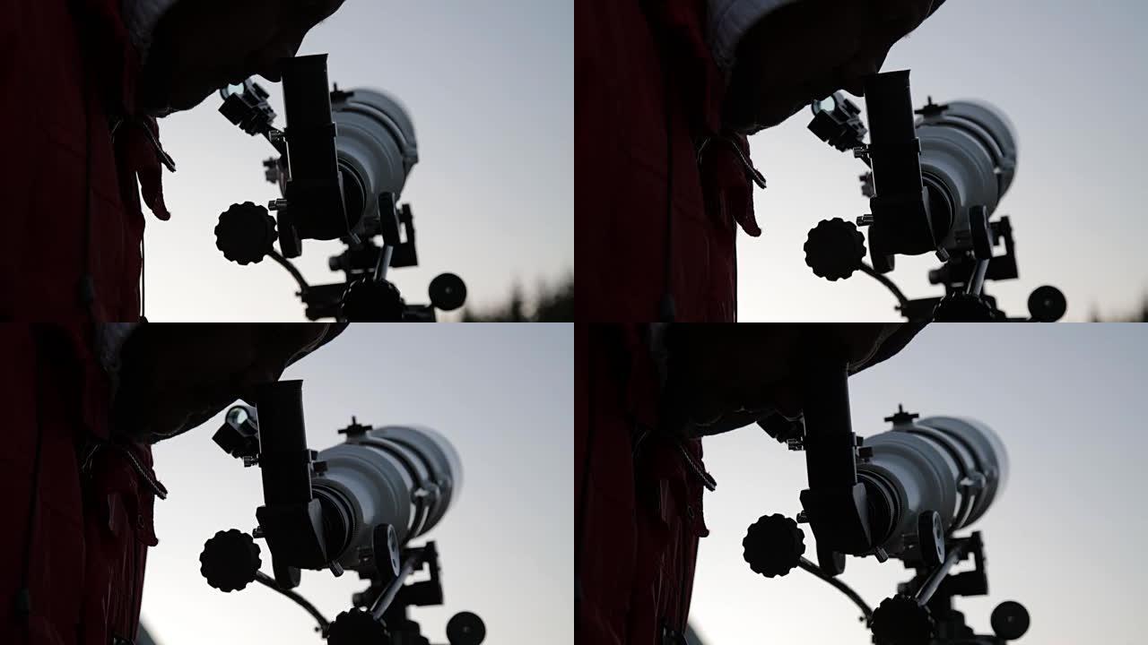 男人通过望远镜看。我的天文学工作。