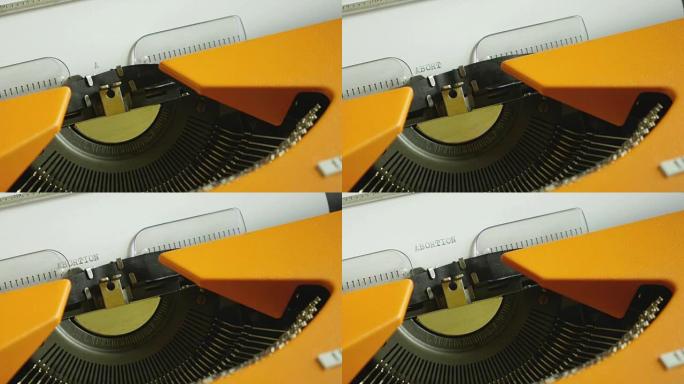 一个人在旧打字机上写流产的高角度镜头，声音