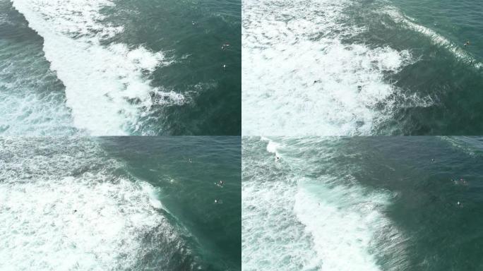 航拍画面，在印度洋冲浪时划着波浪的冲浪者无人机的俯视图，在印度洋冲浪时划着波浪的冲浪者无人机的俯视图