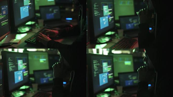 hoodie与多个屏幕和黑客系统一起工作的黑客