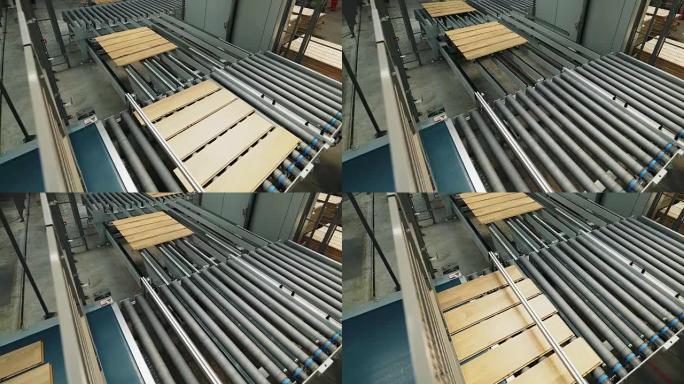 拼花板在木工厂的生产线上进行加工。