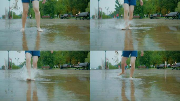 腿的特写，腿在雨中在水坑里泼水