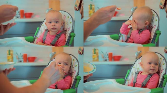 一个可爱的小宝宝吃一勺粥的特写