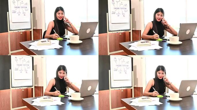 年轻的女商人正在注意从电话中收到的消息。