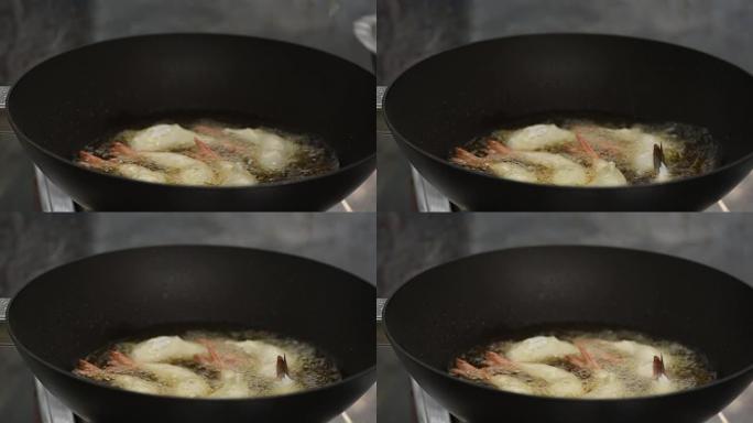 在热锅中烹饪炸虾球