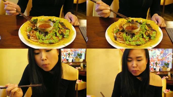 越南女孩的手在吃传统的越南菜