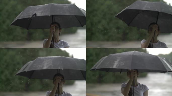 女孩在雨天旋转雨伞，看着雨滴打在雨伞上，秋天的心情，慢动作