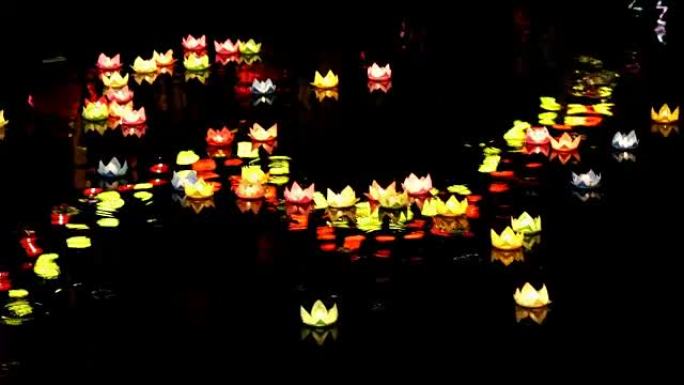 在佛陀诞生的节日中，水中的纸灯笼在晚上照耀在河上。