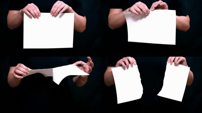 用彩色背景上的一张纸关闭双手。双手撕开一张白纸。