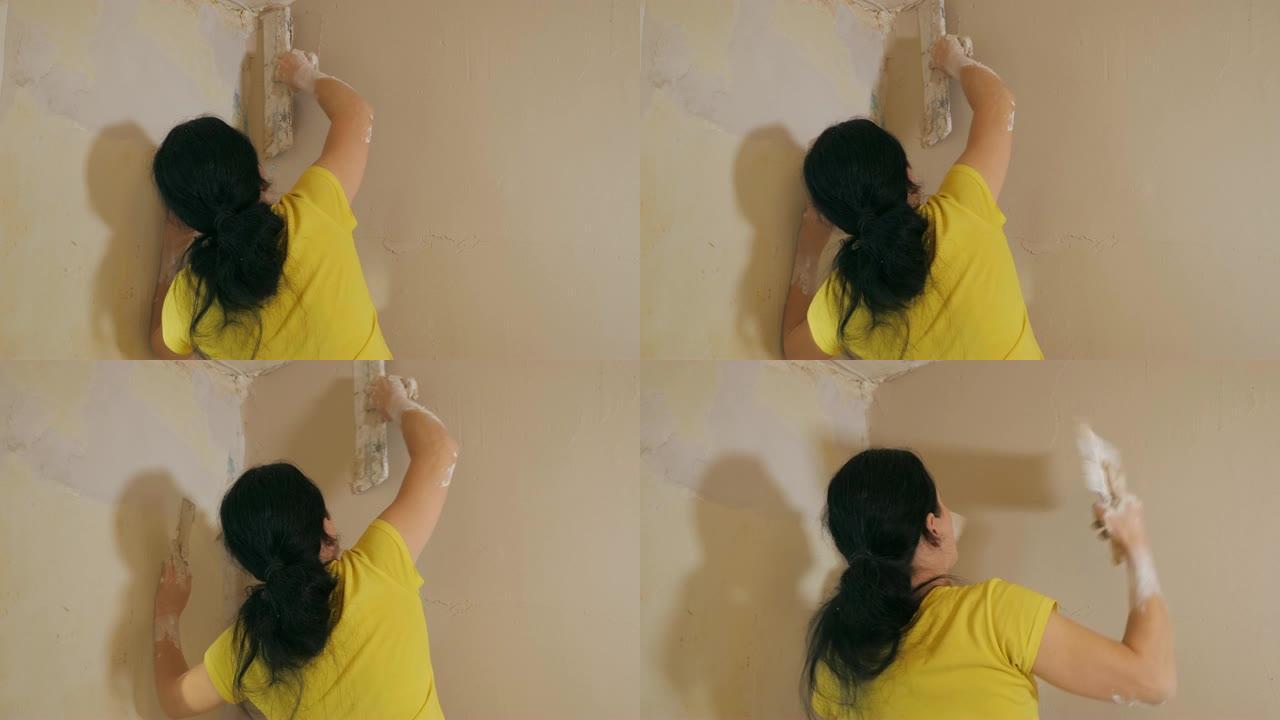 女人用调色板抹灰墙