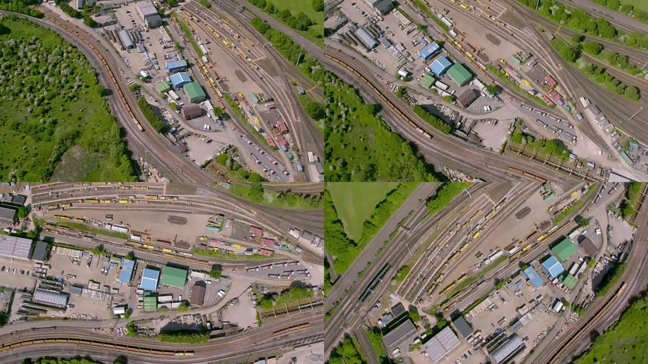 郊区火车仓库和铁路在阳光下的鸟瞰图。4K