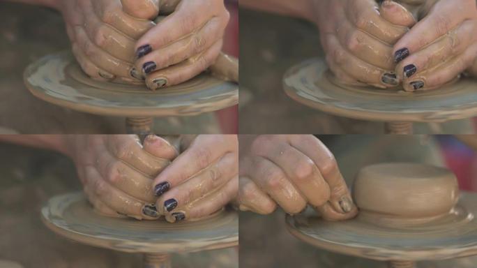 妇女陶工在陶工的轮子上用陶器来塑造粘土产品
