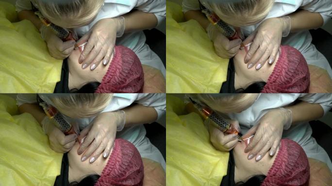 在美容院，一个女人做下唇的纹身。专业美容师用针将颜料涂在女人的嘴唇上。