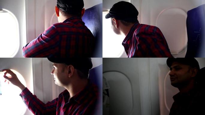 男人透过飞机窗户看，关上窗户