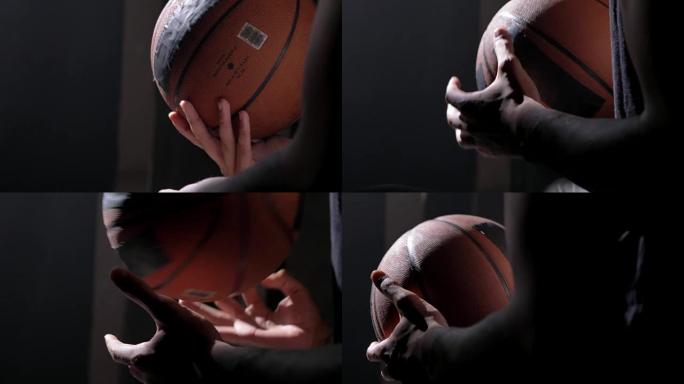 黑人男子的手与纹身玩球的近距离镜头
