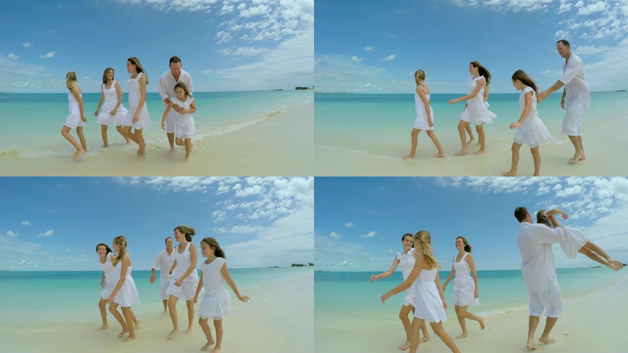 白种人家庭赤脚穿着白衣服在海滩上