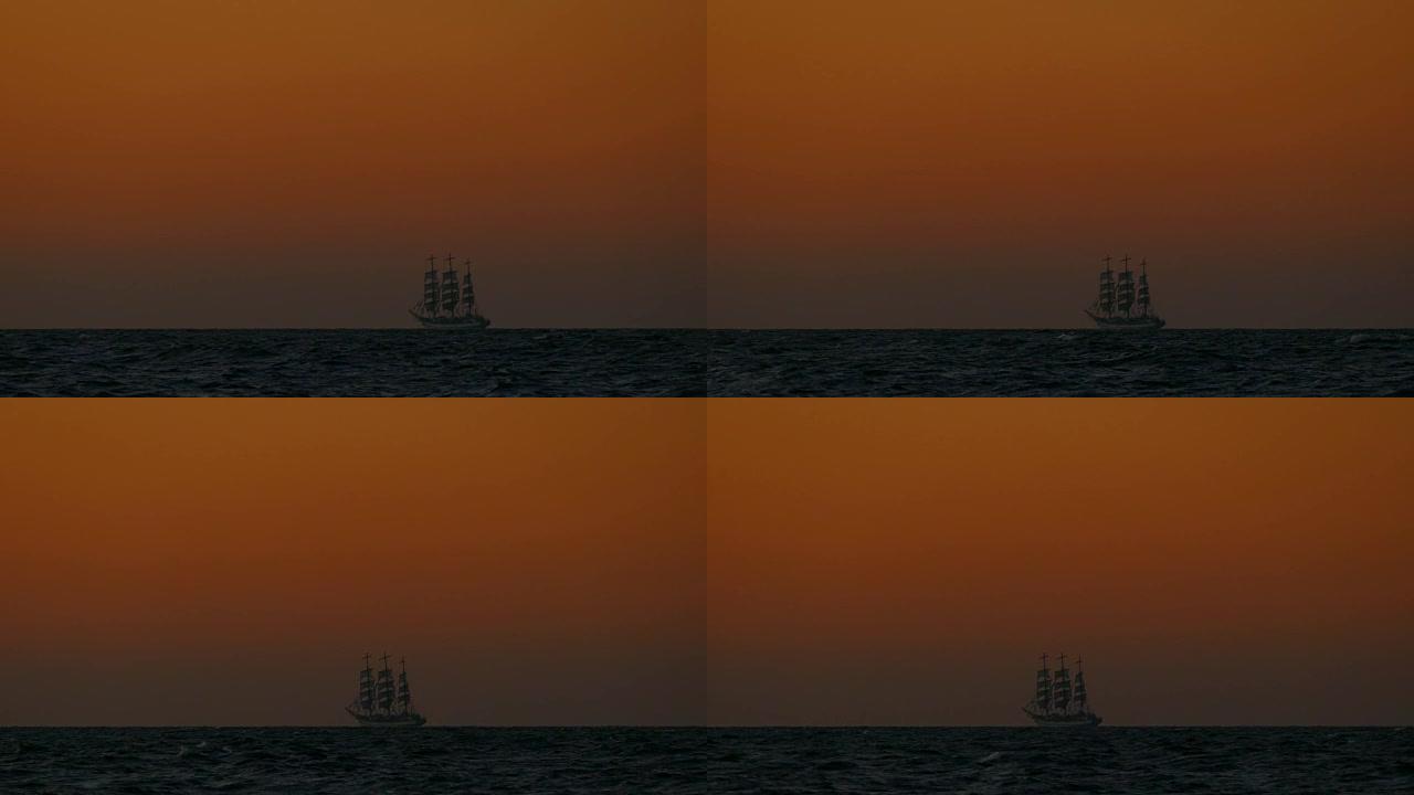 海中日落时高高的船的剪影