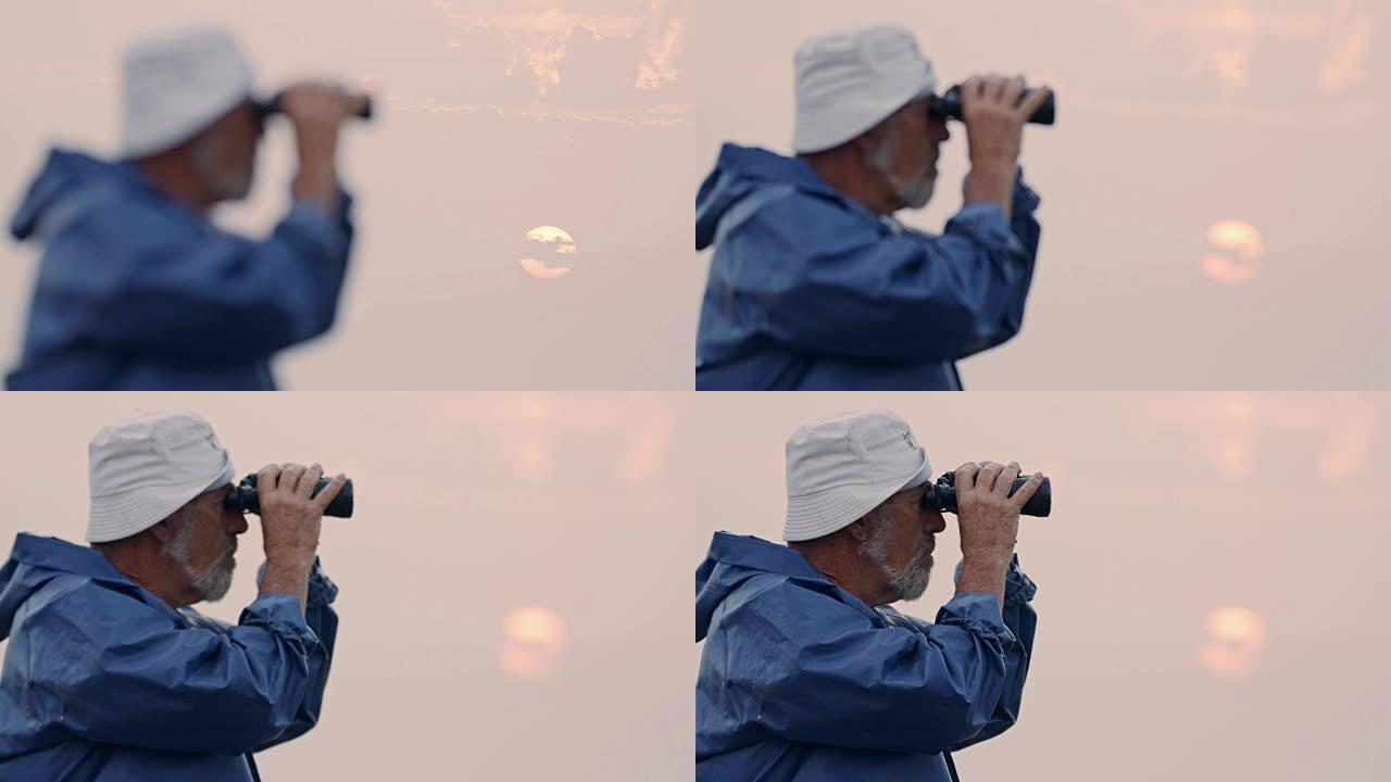 老渔夫用双筒望远镜望向大海