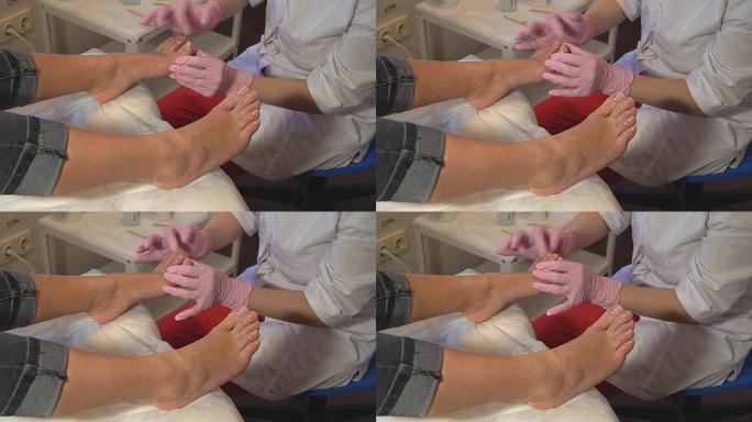 沙龙里修脚。主人照顾客户的指甲和脚，做修脚。脱皮脚修脚程序