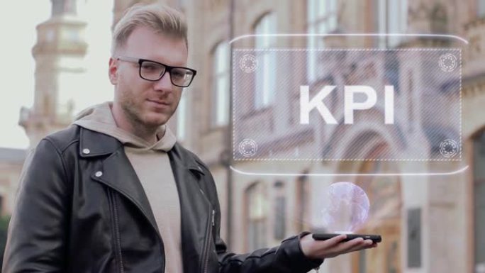 戴眼镜的聪明年轻人展示了概念性全息图KPI