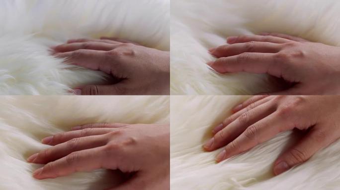 一只手触摸羊毛衫