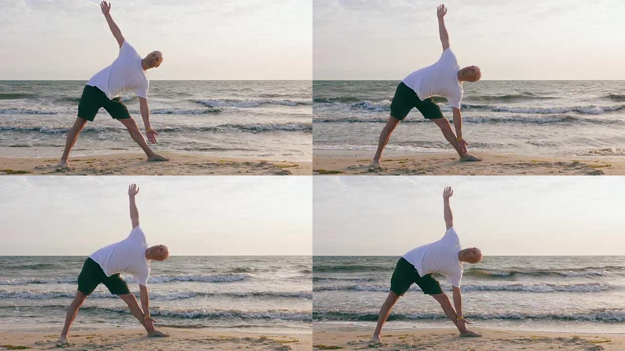 在海边的伸展三角体式练习瑜伽的运动员