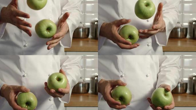 特写: 首席炊具在厨房里摆弄青苹果-慢动作