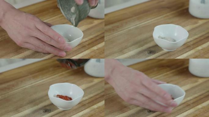 在杵和研钵中向盐和胡椒中加入辣椒粉