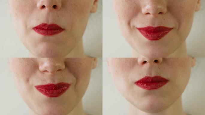 嘴唇红红的女人吃草莓。嘴巴特写。前视图。