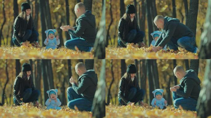 小孩子和他们的父母在公园晴朗的秋日向空中扔黄叶