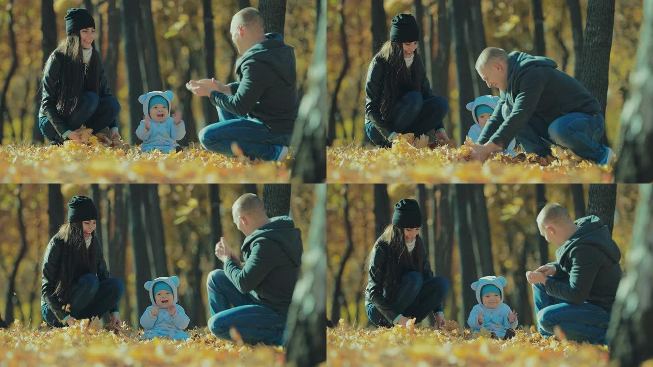 小孩子和他们的父母在公园晴朗的秋日向空中扔黄叶