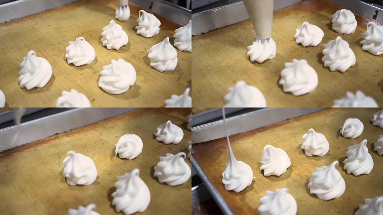 跟随人类使用糕点或管道袋在厨房的面包店托盘上挤出白色鲜奶油的酥皮