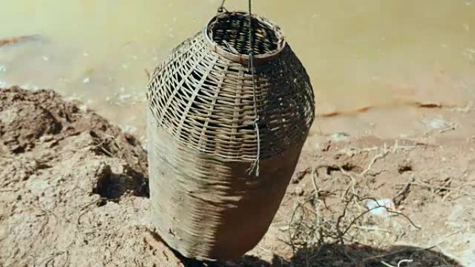 圆柱形鱼具，由分裂的竹条制成，用于在大风天用竹棍在水边钓鱼。