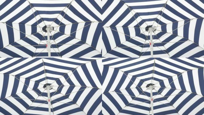 阳伞织物具有催眠效果，随风移动4K 2160p 30fps超高清镜头-蓝色和白色条纹沙滩伞防晒384