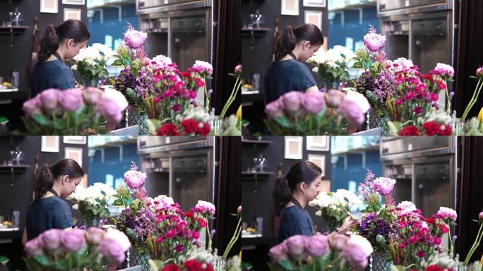 从事鲜花工作的年轻女花店。