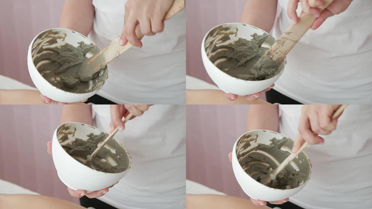 在碗中混合粘土以进行美容处理