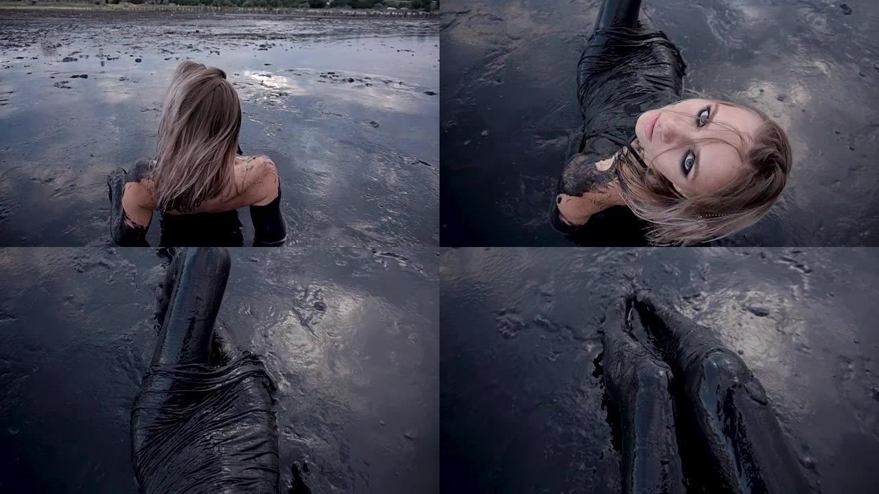 女人躺在黑泥中看起来像石油