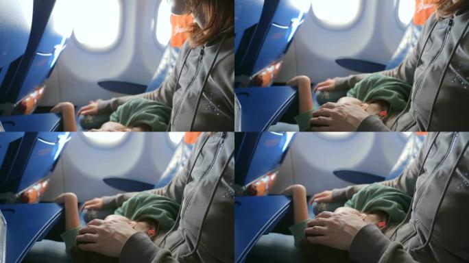 母亲和她熟睡的小女孩坐飞机