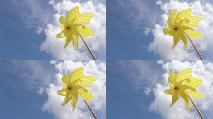 黄色风车玩具对抗蓝天。夏季概念