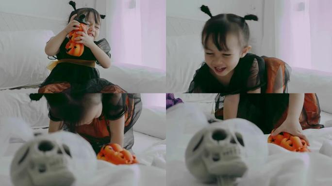 泰国女婴在家里和妈妈玩万圣节派对时，害怕和骷髅娃娃