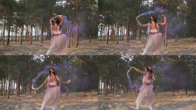 迷人的女人，穿着粉红色的连衣裙，在松树的背景上与烟雾弹共舞。一个性感女孩的舞蹈，有着美妙的发型和鲜花