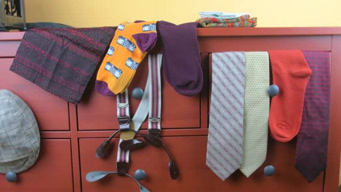 男装。男士服装概念。紫红色背景上的彩色袜子、领带、背带、围巾和格子平帽。男装的经典概念。Wintag