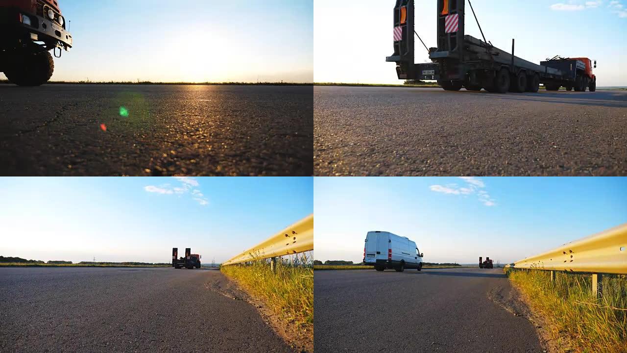 摄像机跟随卡车沿着农村的高速公路行驶。卡车穿越乡村，背景是美丽的风景。在乡村高速公路上查看。慢动作